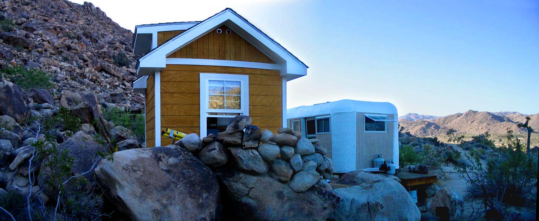An overview of the completed shed exterior, deck and trailer